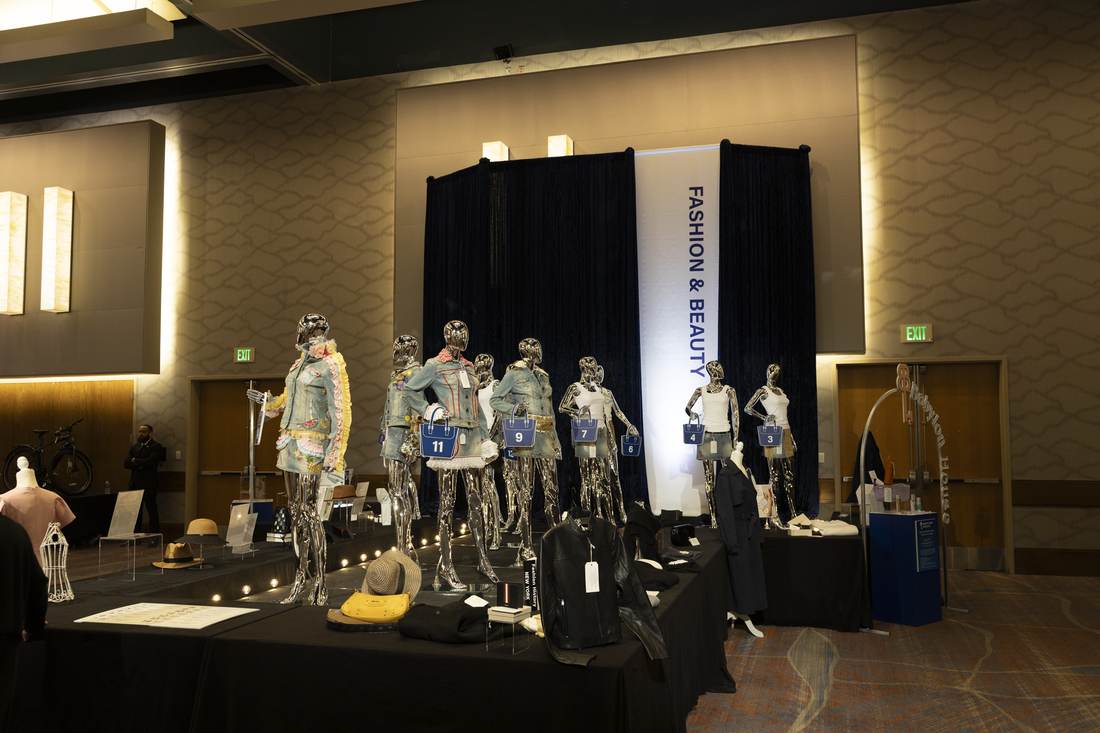 Full row of mannequins with numbered purses, denim pieces