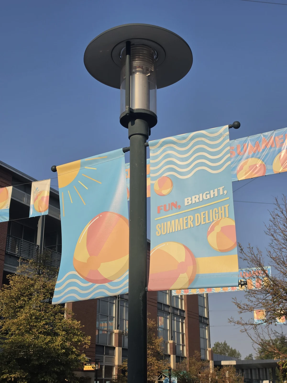 Close view of a beach ball pole banner against blue sky