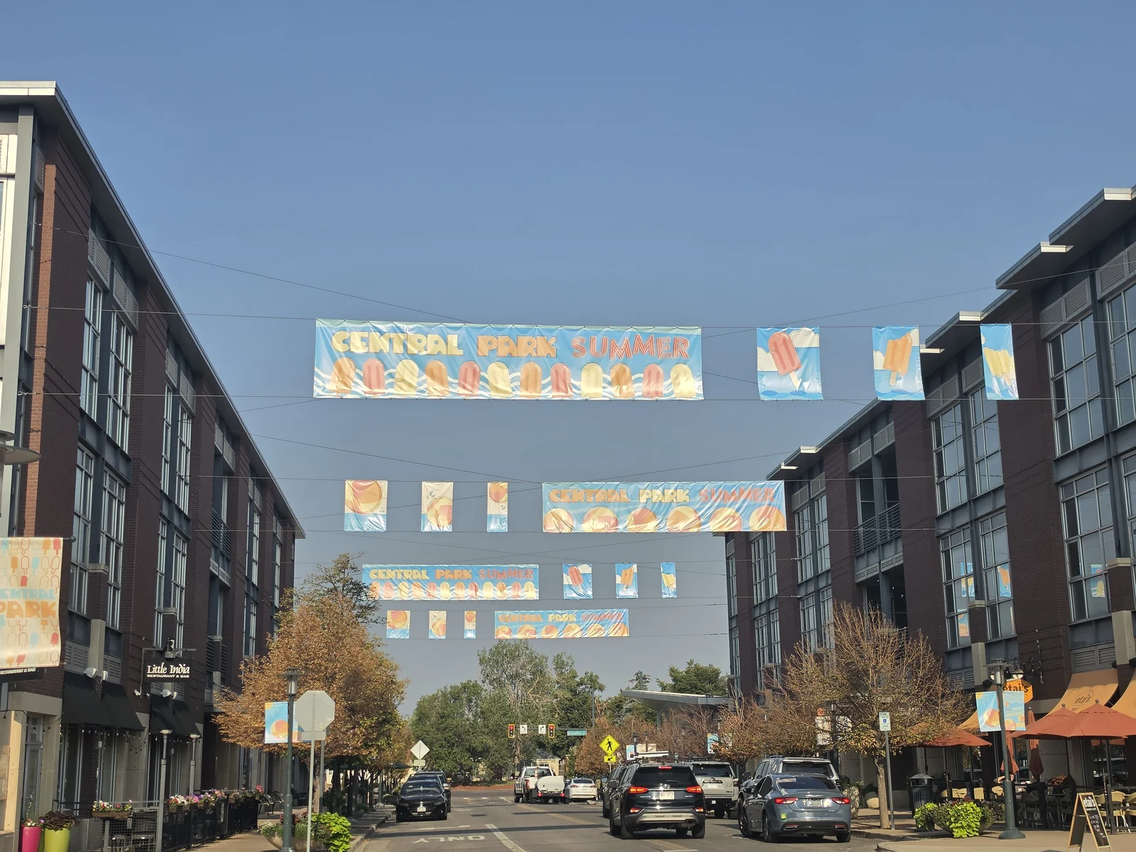 Street-spanning Central Park Summer banners crossing above the town square