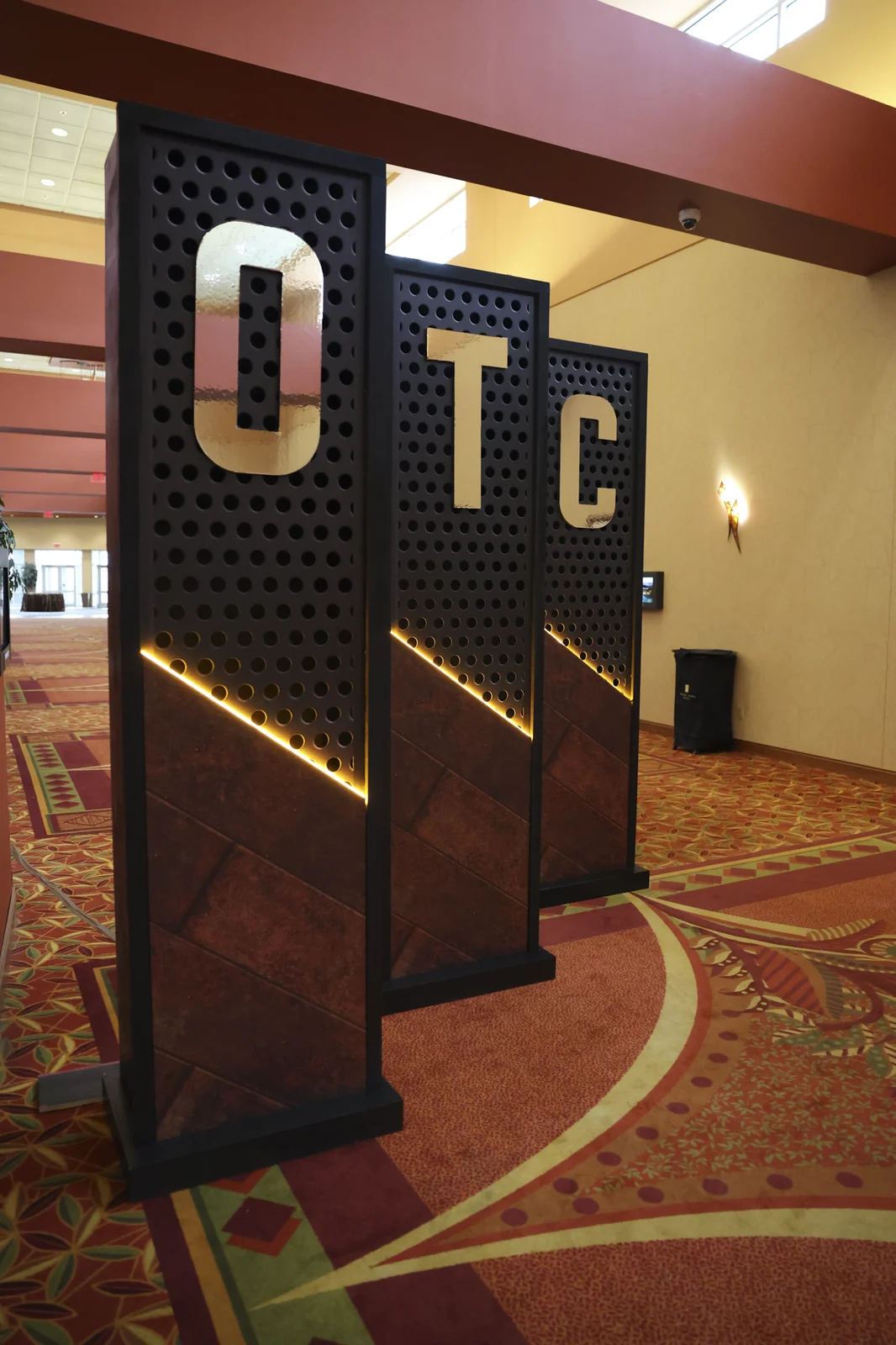 The entrance pillars seen at an angle with their lighting visible