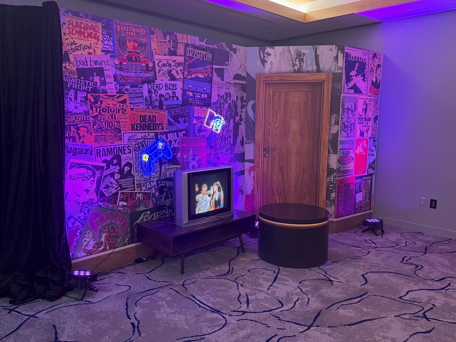 The finished dorm room photo booth under purple lighting