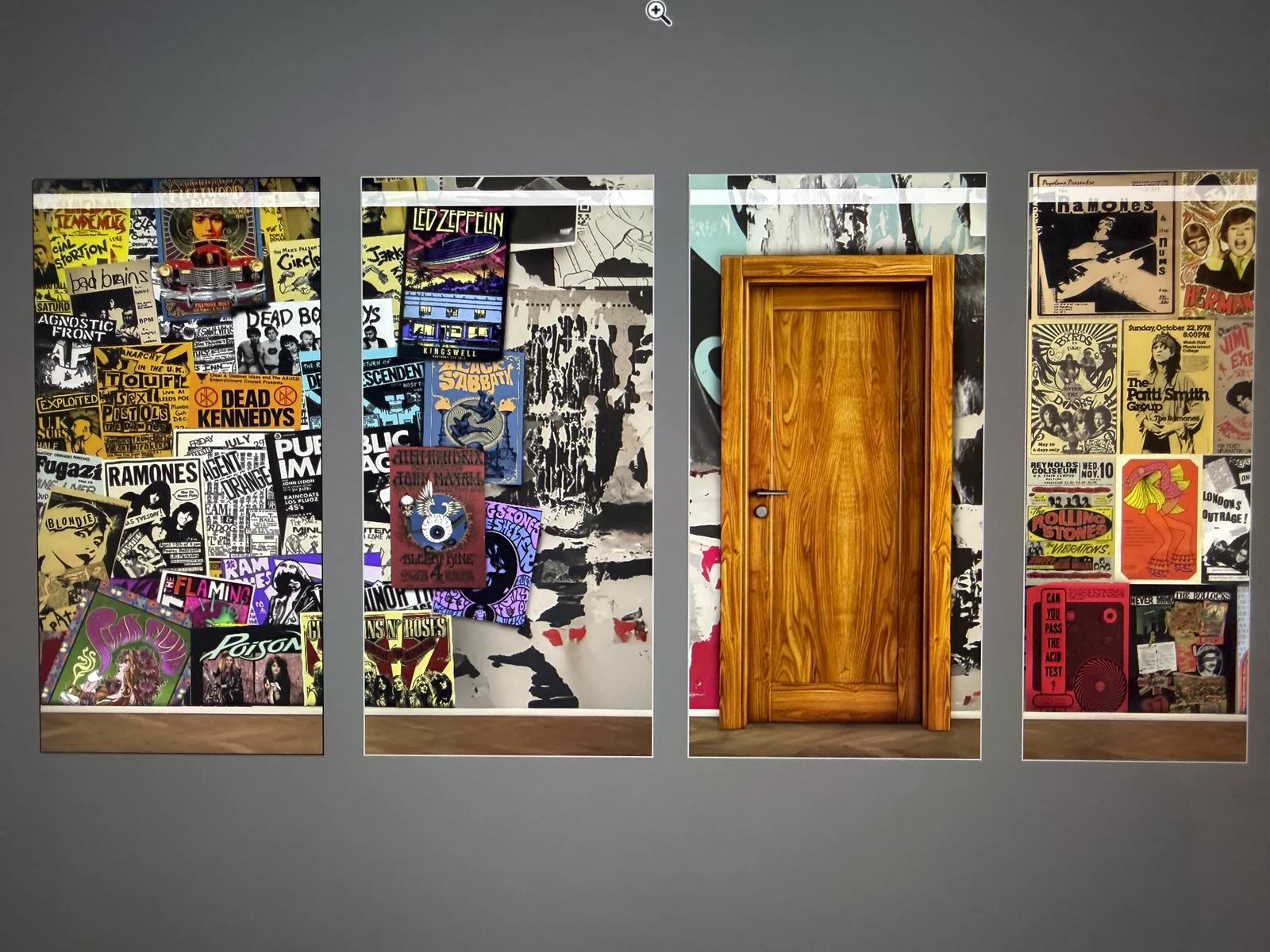 The dorm room wall vinyls laid out flat — panels of layered band posters with a wooden door panel