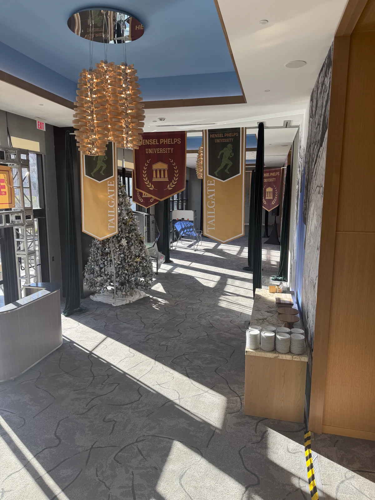 Concourse hung with crest banners beneath a chandelier