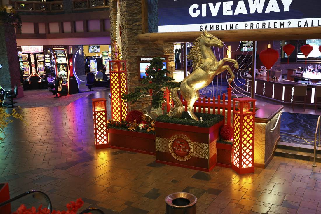 Gold horse statue with branded planter base, wide view