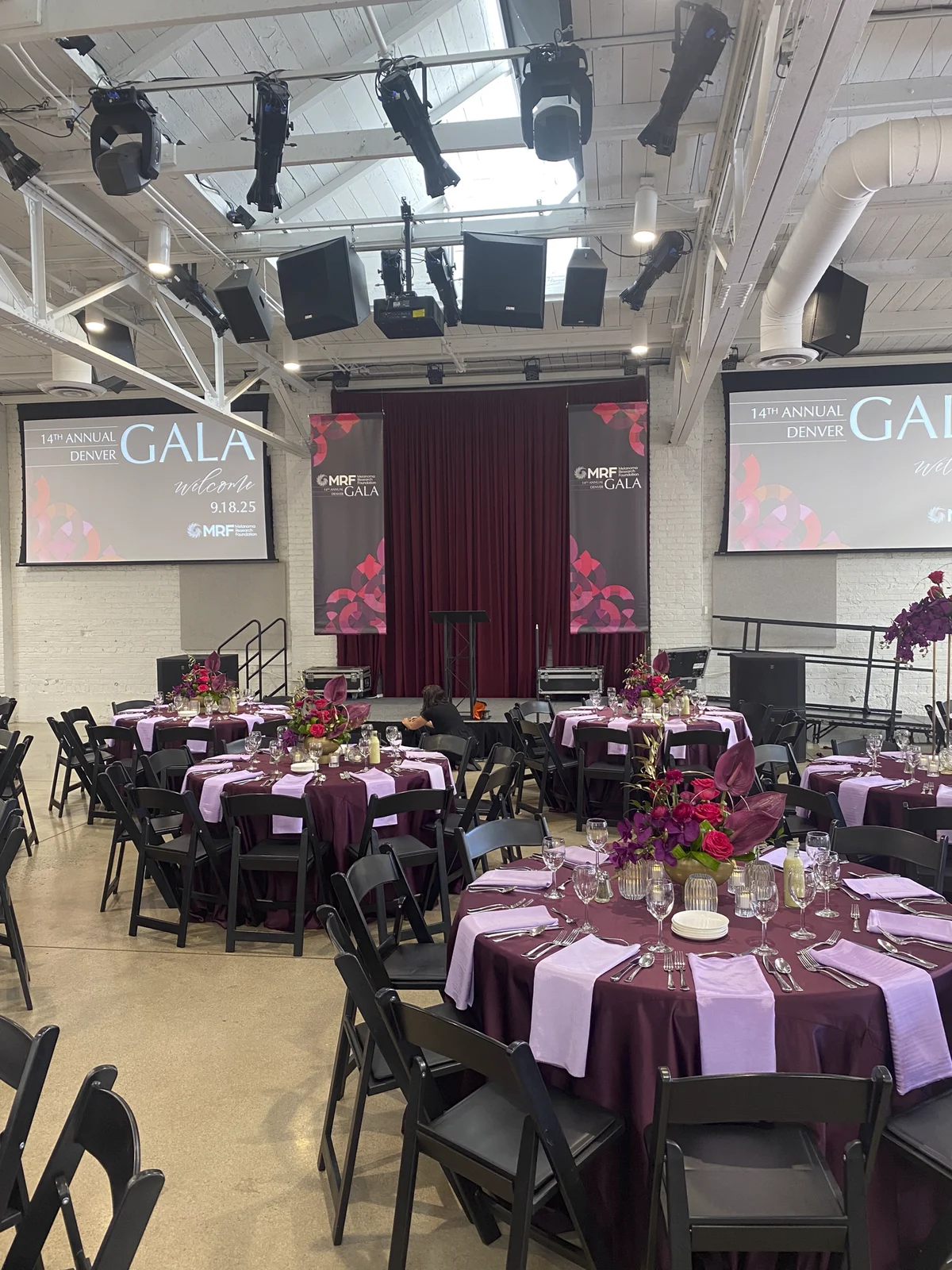 Vertical MRF Denver Gala banners hanging above the guest tables