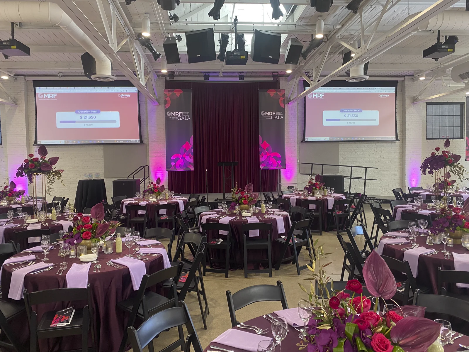 The ballroom under evening lighting with the program on screen