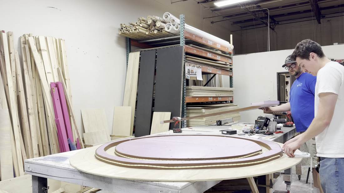 Building the layered tree-ring piece with the in-house carpenter