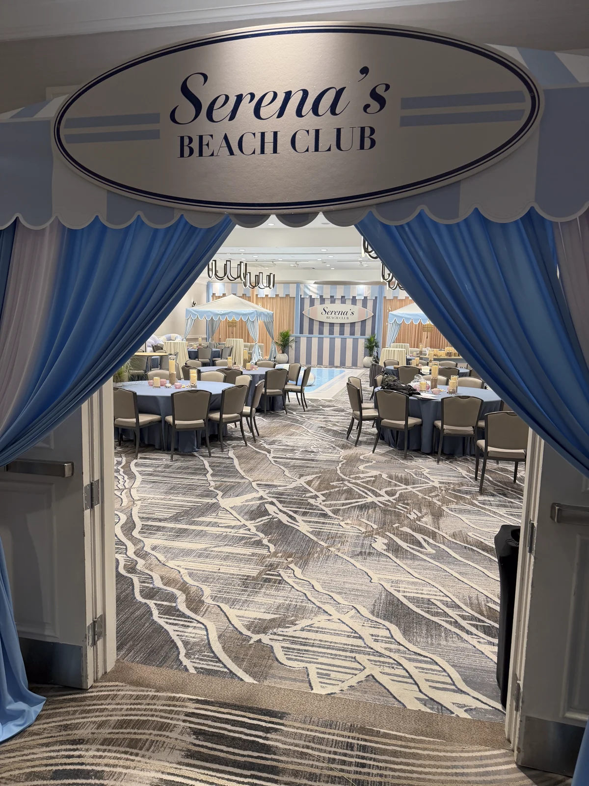 Ballroom entrance facade with striped awning and the Serena's Beach Club oval sign