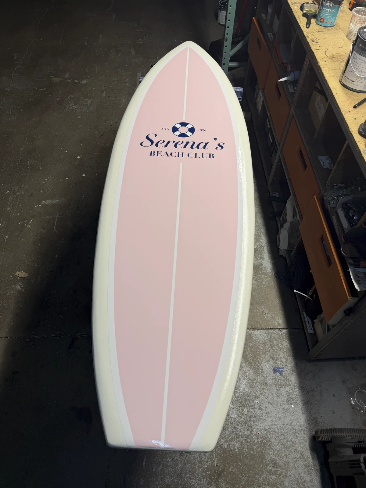 Finished branded surfboard standing in the shop before transport