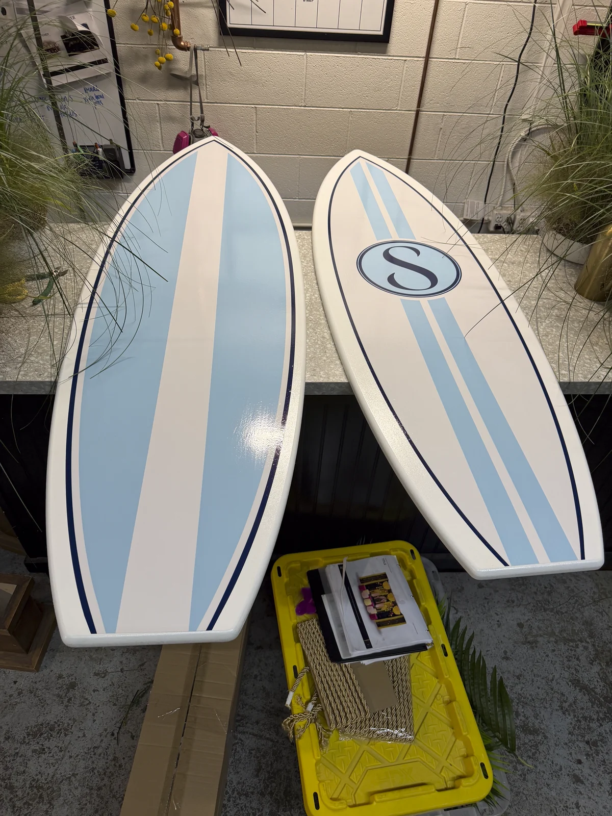 Surfboard signage laid out in the shop during fabrication