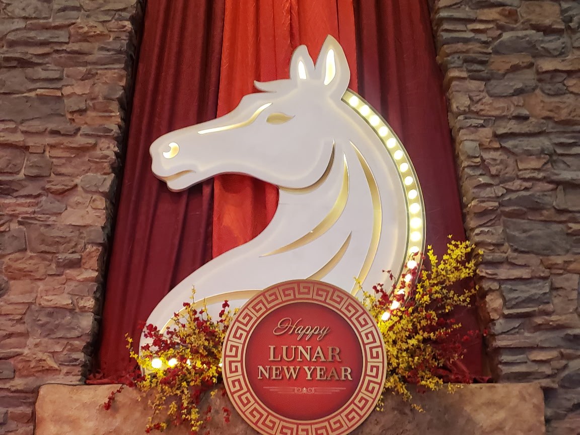 Illuminated horse-head medallion above the casino fireplace for Lunar New Year