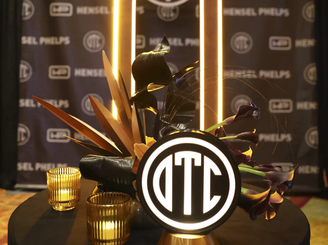 Illuminated OTC monogram above the Old Timers Club banquet stage